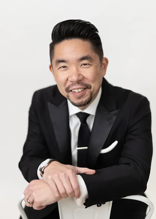 chicago wedding photographer kenny nakai in tuxedo on white background
