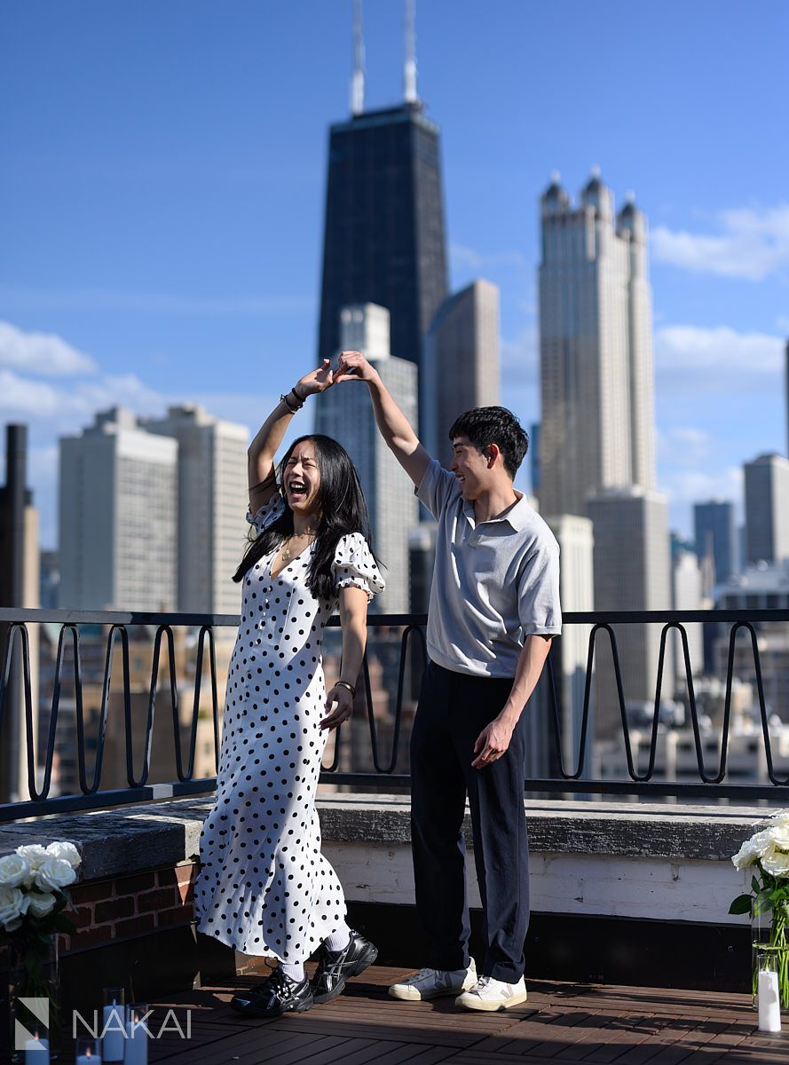 emotional during dancing at ambassador chicago proposal skyline in background