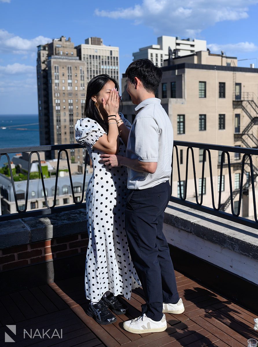 emotional during chicago private proposal skyline in background