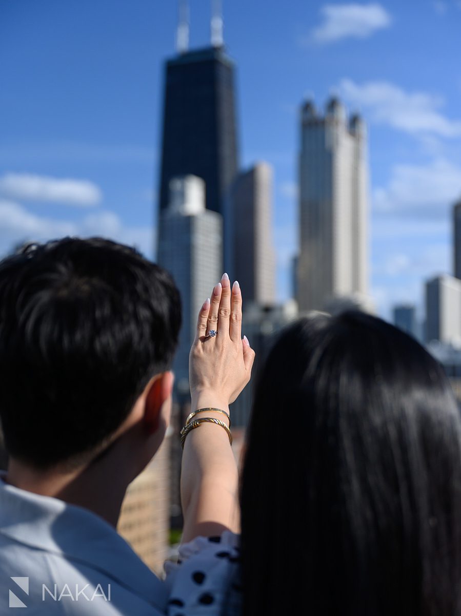 emotional during looking at ring during chicago private proposal skyline in background