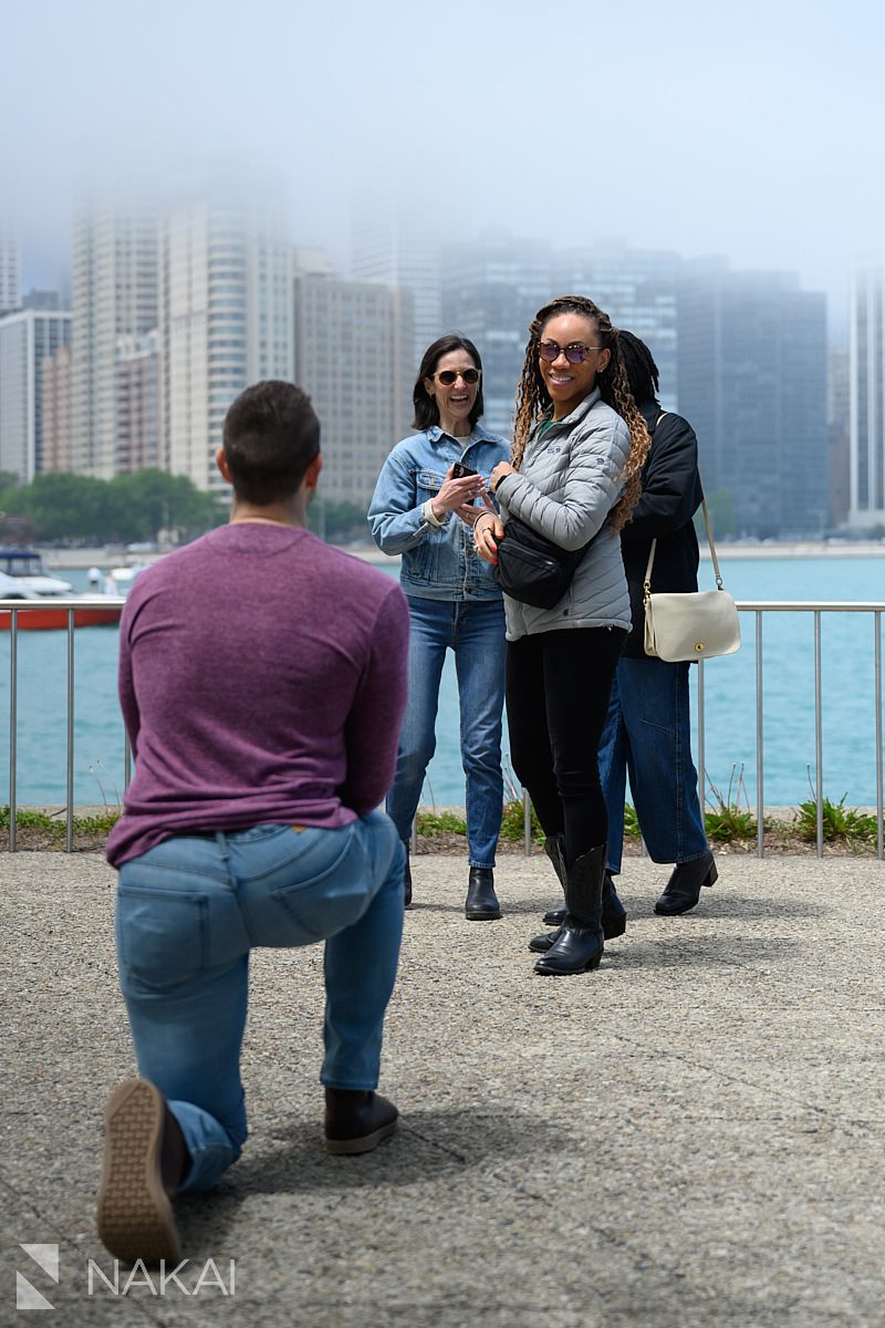 smiling surprised look at chicago lakefront proposal olive park