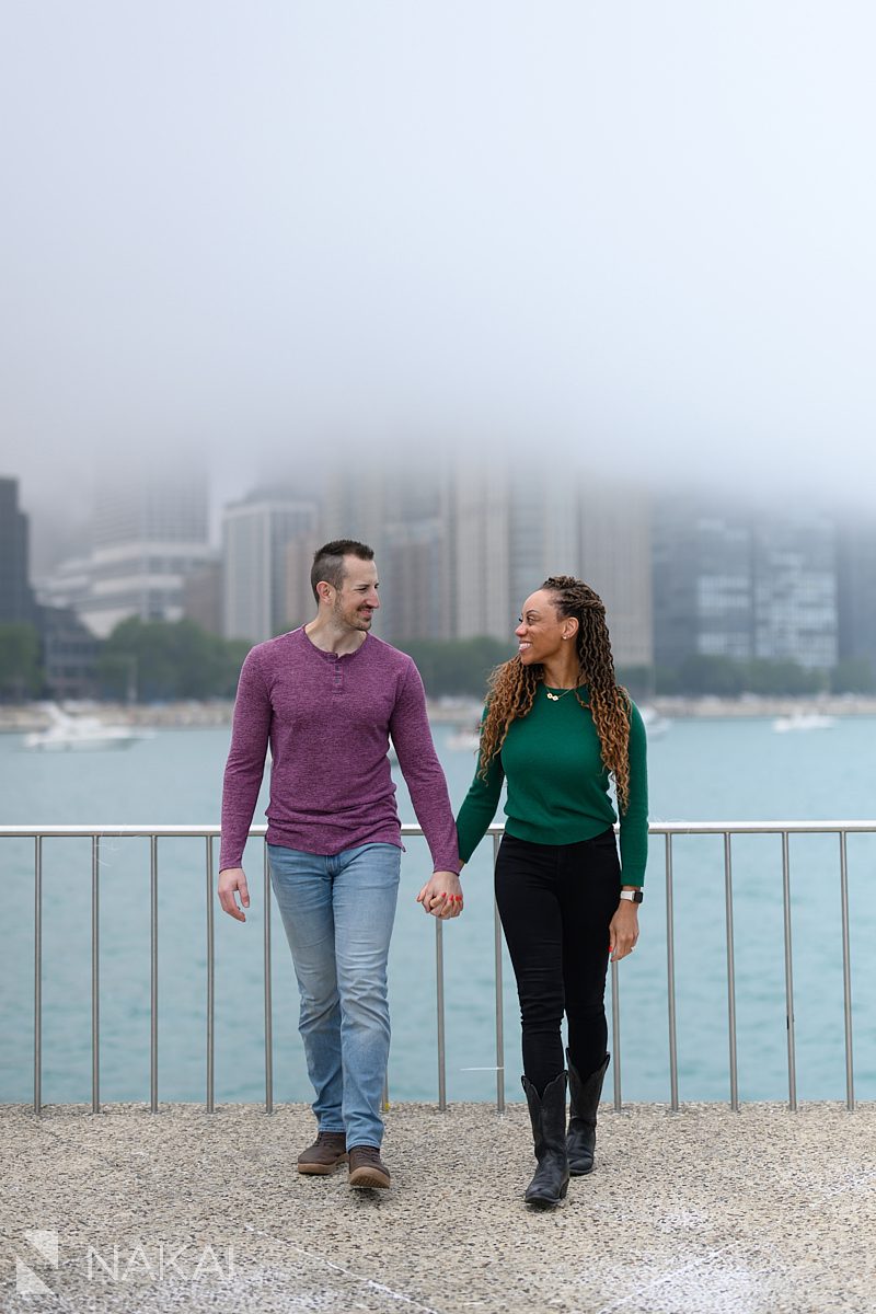 walking holding hands during engagement chicago lakefront photos