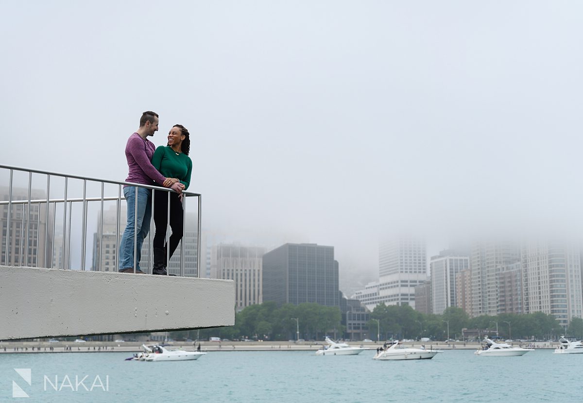 embracing on pier engagement photos chicago lakefront