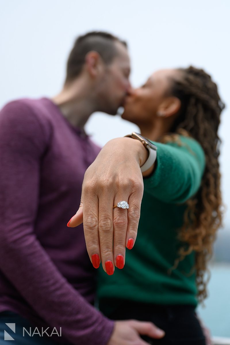 ring in foreground, kiss in background, olive park chicago lakefront proposal