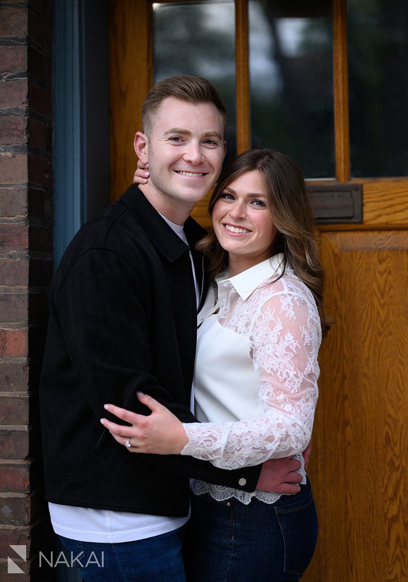 couple in front of door old town chicago engagement pictures