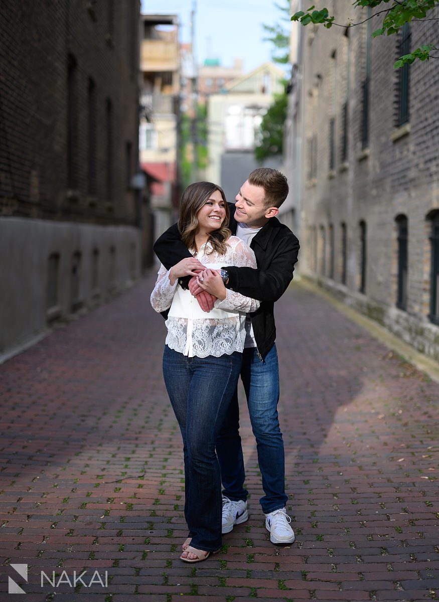 couple in alley hugging old town chicago engagement pictures