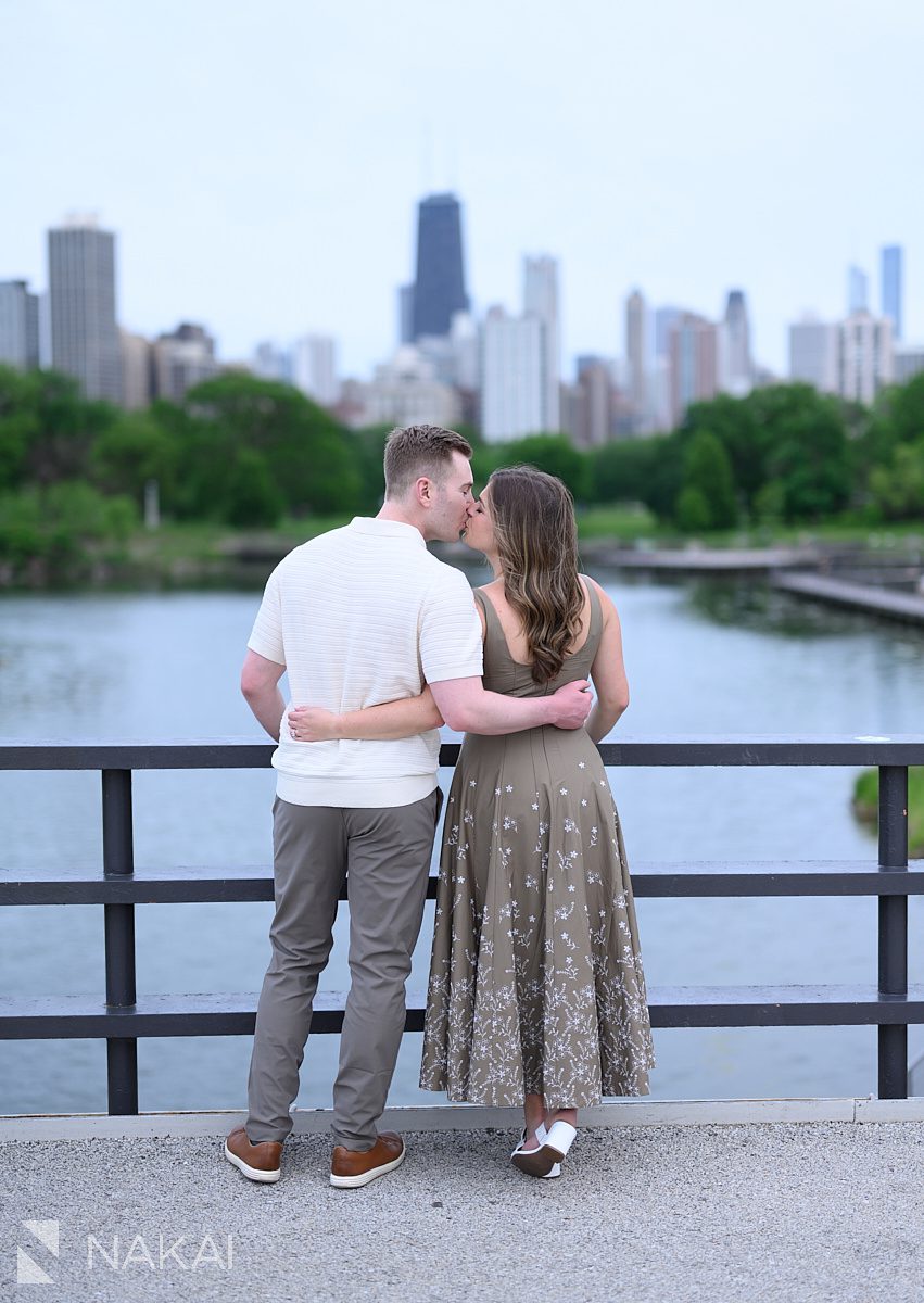 couple kissing on bridge south pond chicago engagement photo