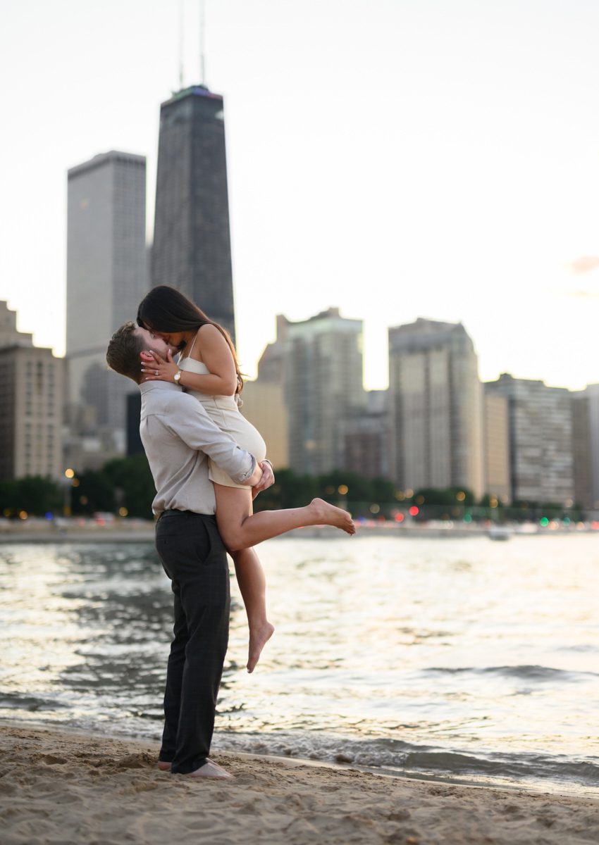 lift and kiss at Chicago oak st beach engagement