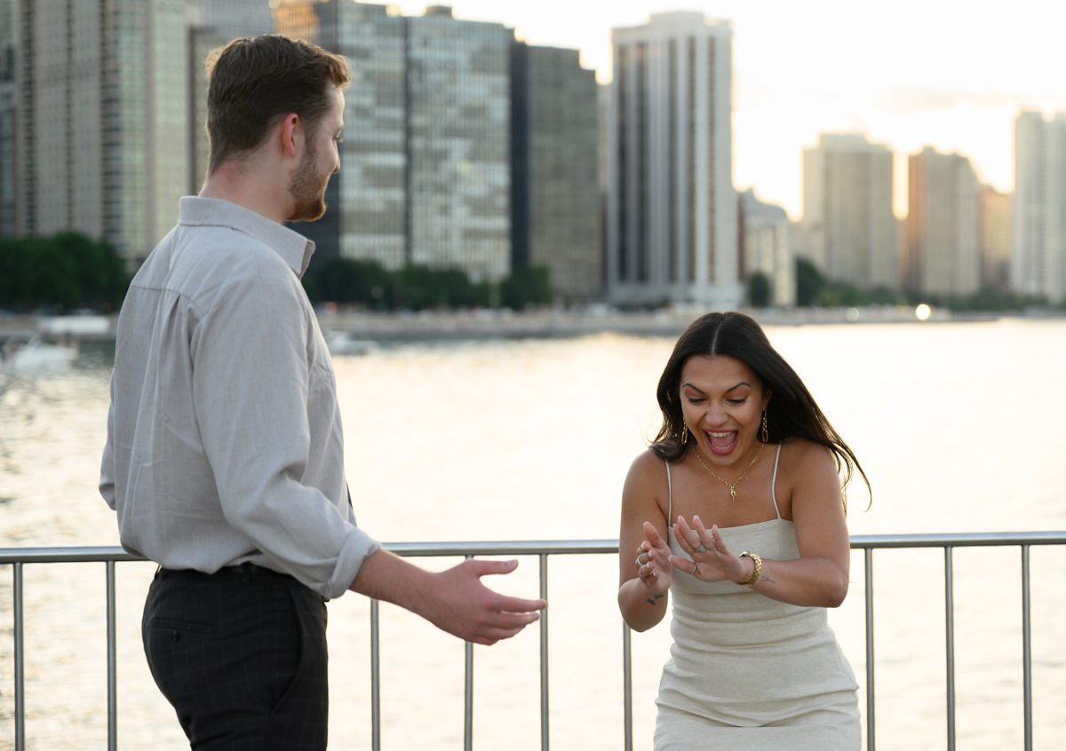 looking at ring on her finger after surprise proposal chicago