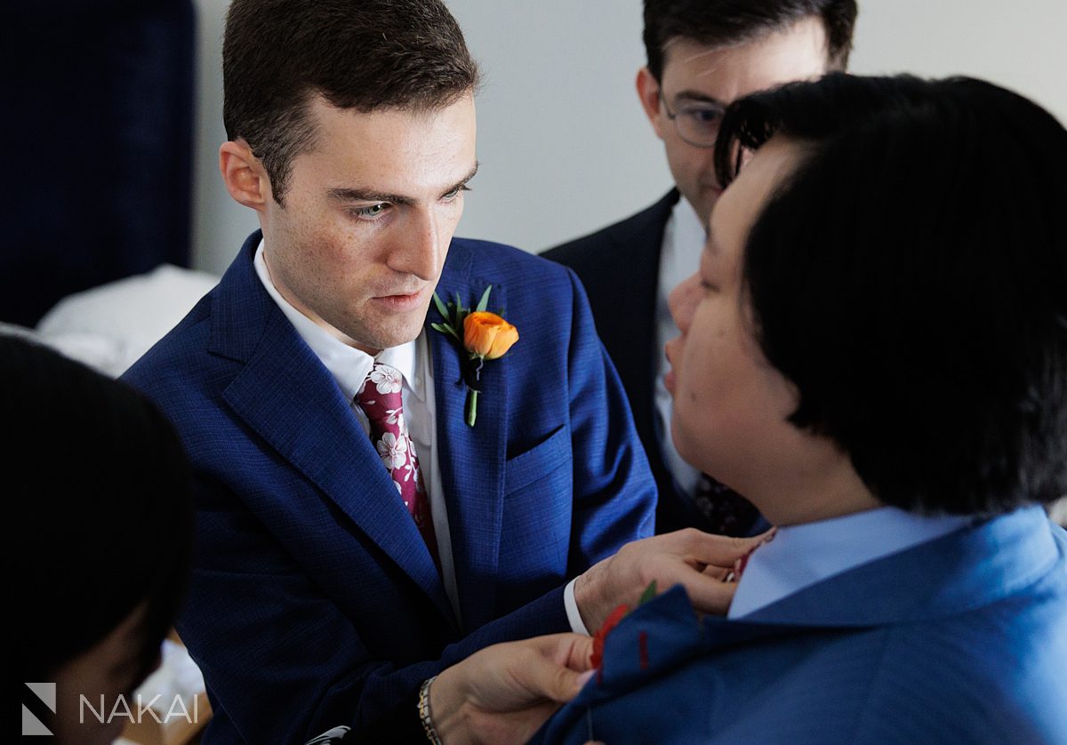 hotel lincoln wedding groomsmen helping put on tie
