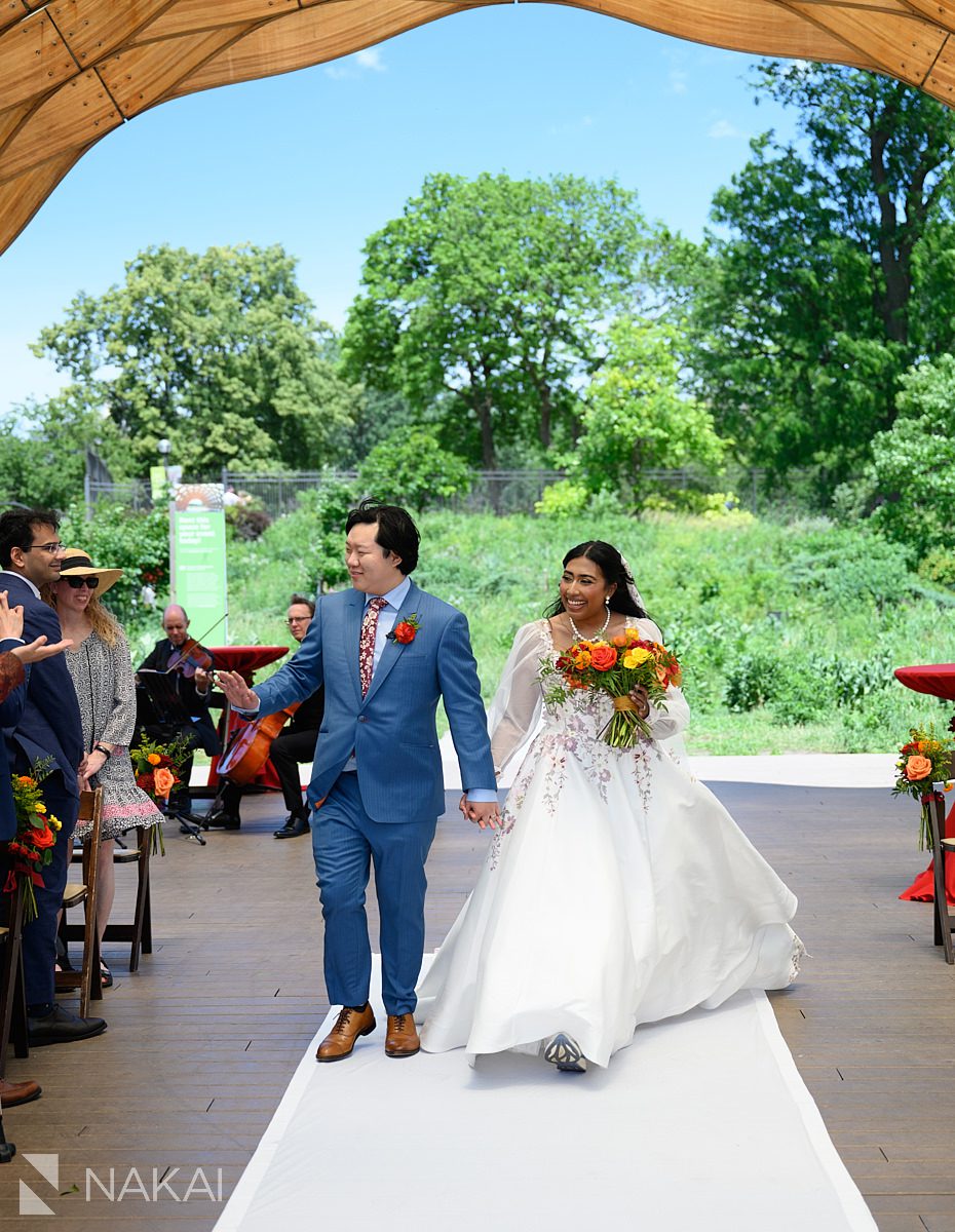 people's gas pavilion wedding ceremony bride and groom walking down aisle