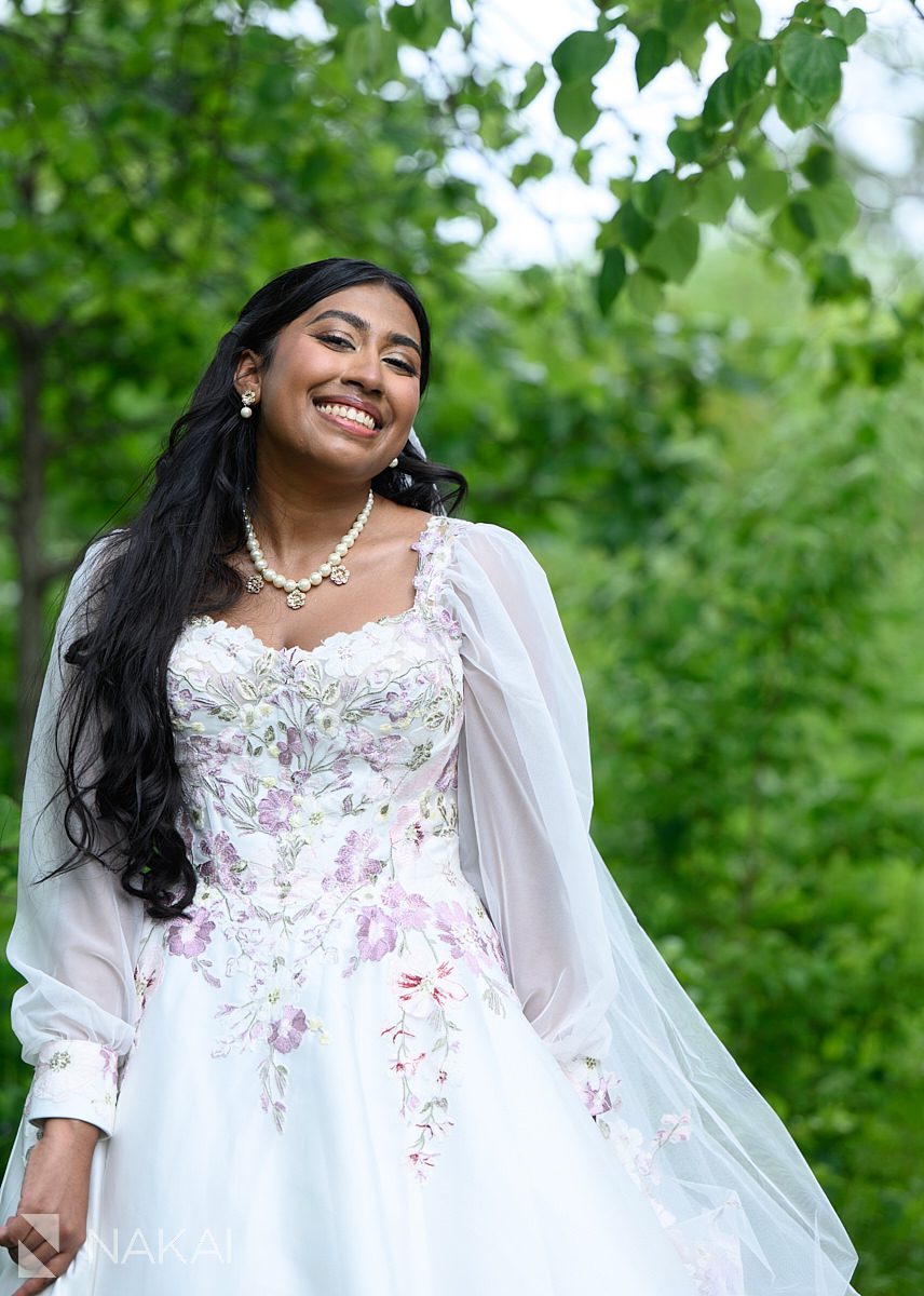 south asian bride smiling in chicago in nature