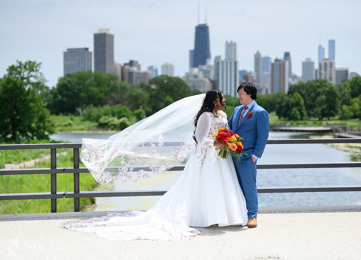 bride and groom on south pond bridge wedding photo veil blowing in breeze