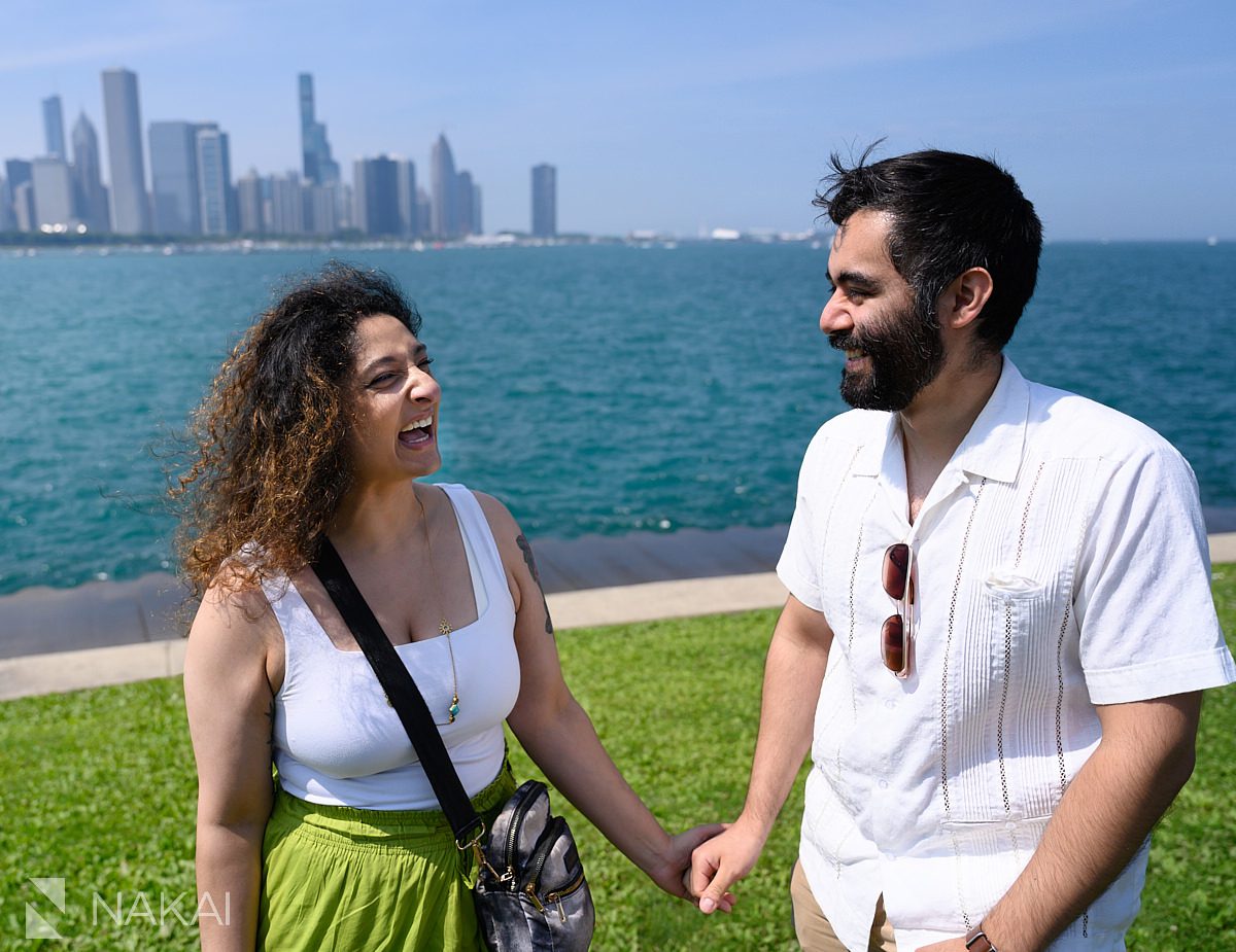 holding hands and smiling after adler planetarium proposal