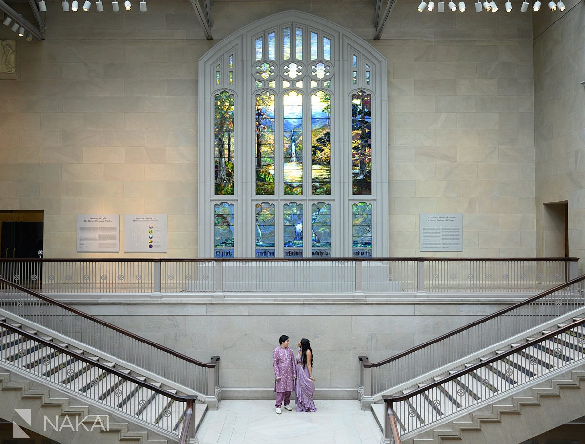 chicago art institute engagement photo couple on staircase beneath stained glass