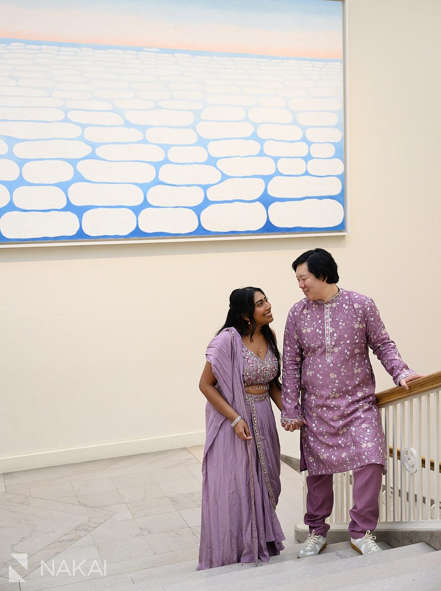 on stairwell in front of O'keefe painting art institute engagement picture