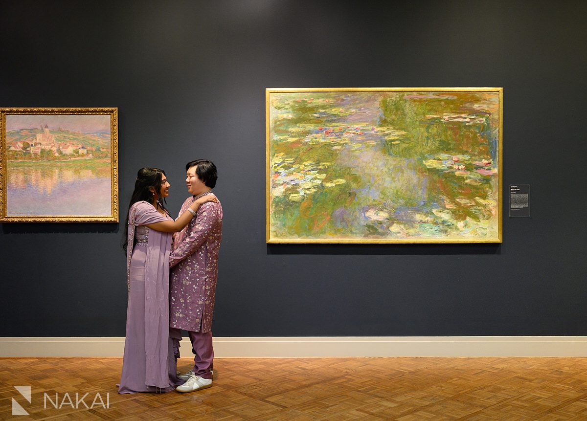 south asian couple standing in front of impressionist painting