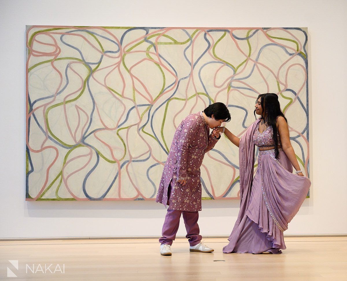 kissing her hand in modern wing at art institute engagement photo