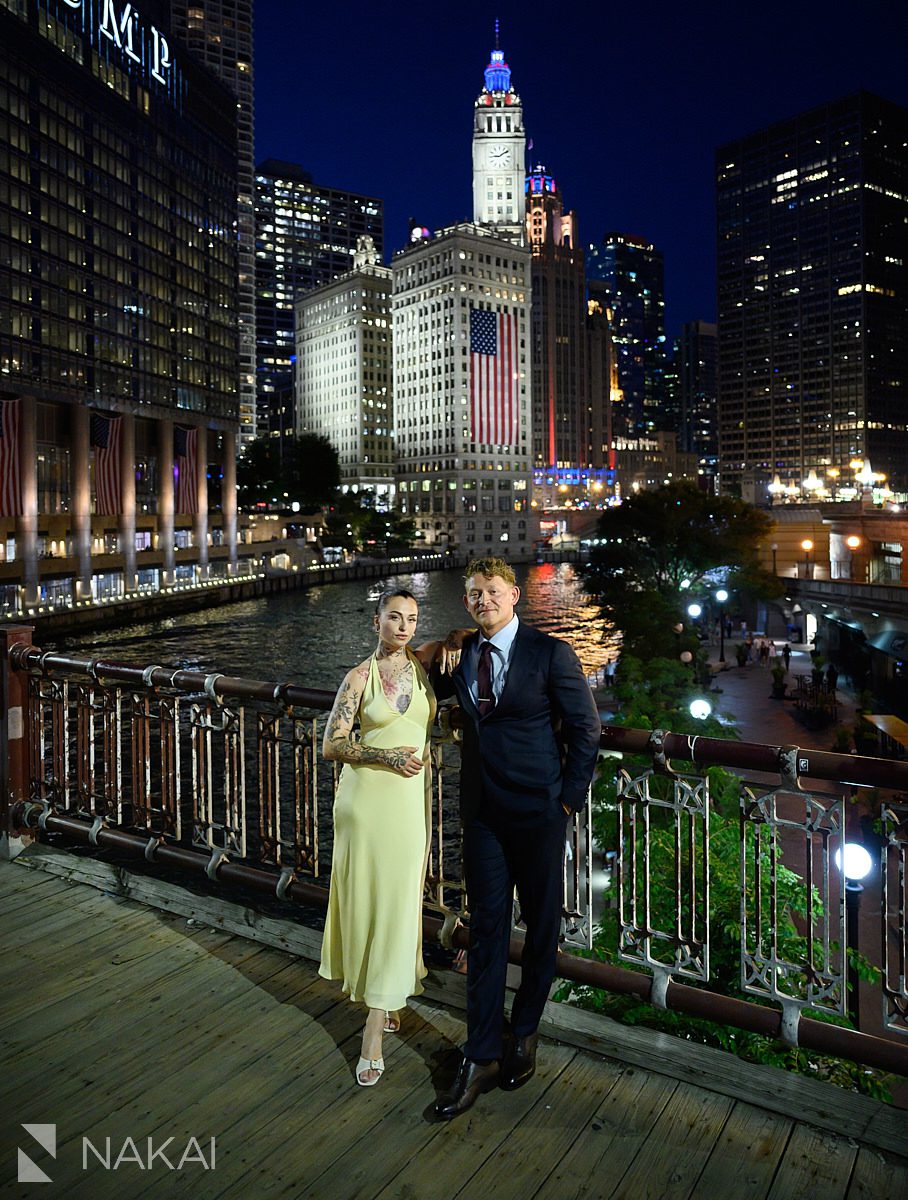 on bridge wrigley building in background chicago night time riverwalk engagement