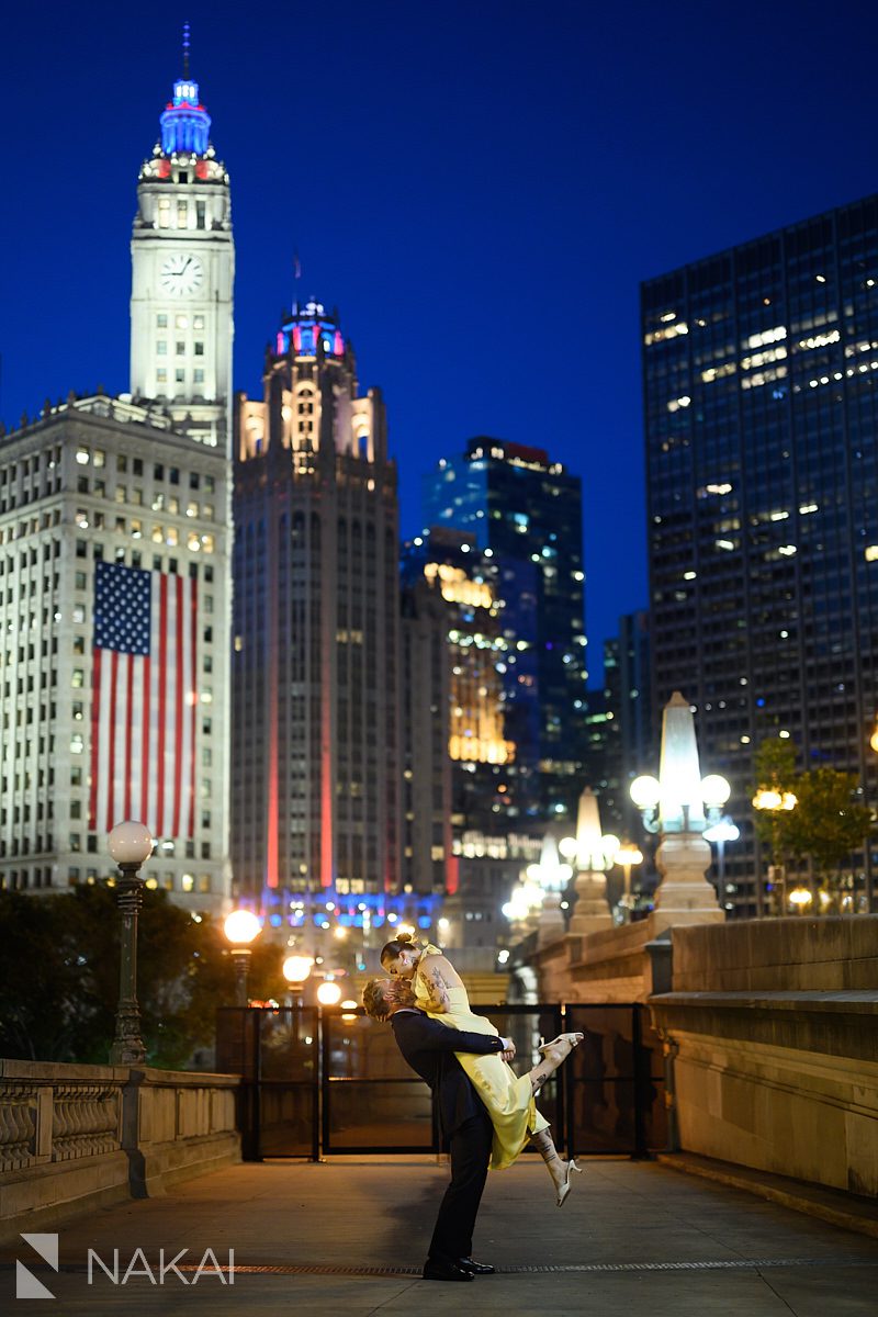 lift and kiss during chicago riverwalk engagement at night