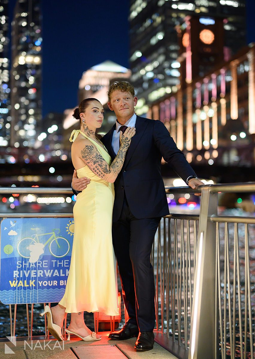 standing look out during chicago riverwalk engagement at night
