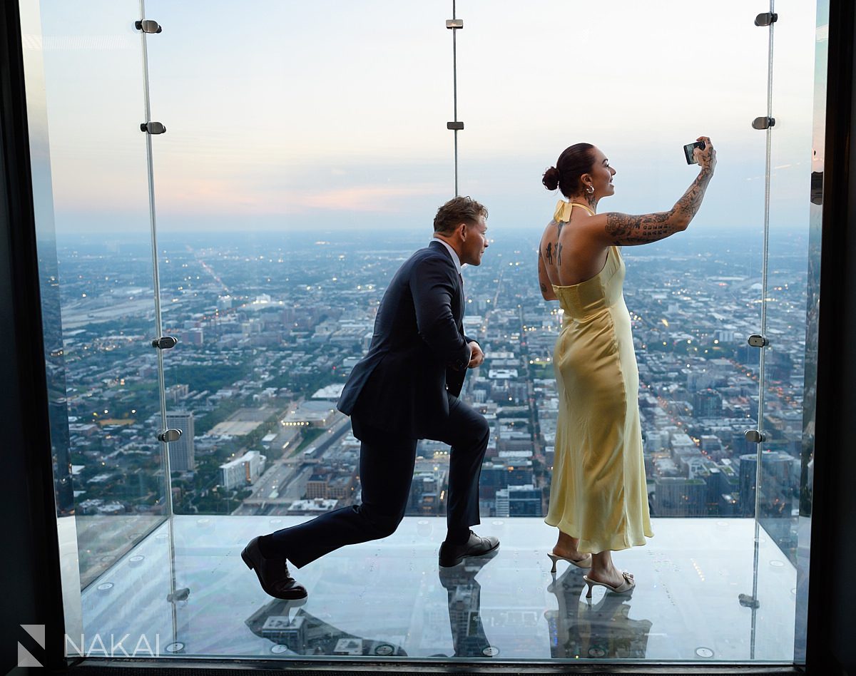 suit and yellow dress chicago skydeck proposal at willis tower