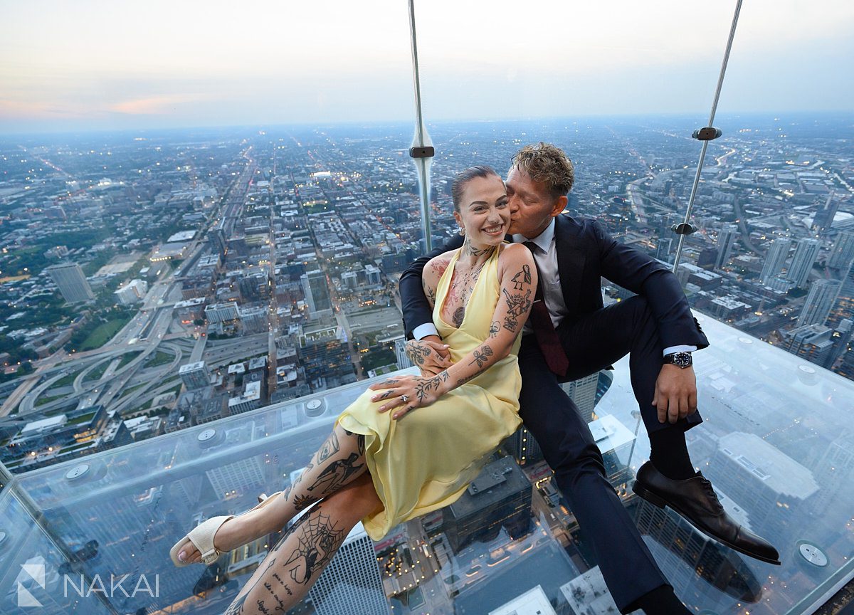 sitting on ledge at chicago willis tower skydeck proposal 