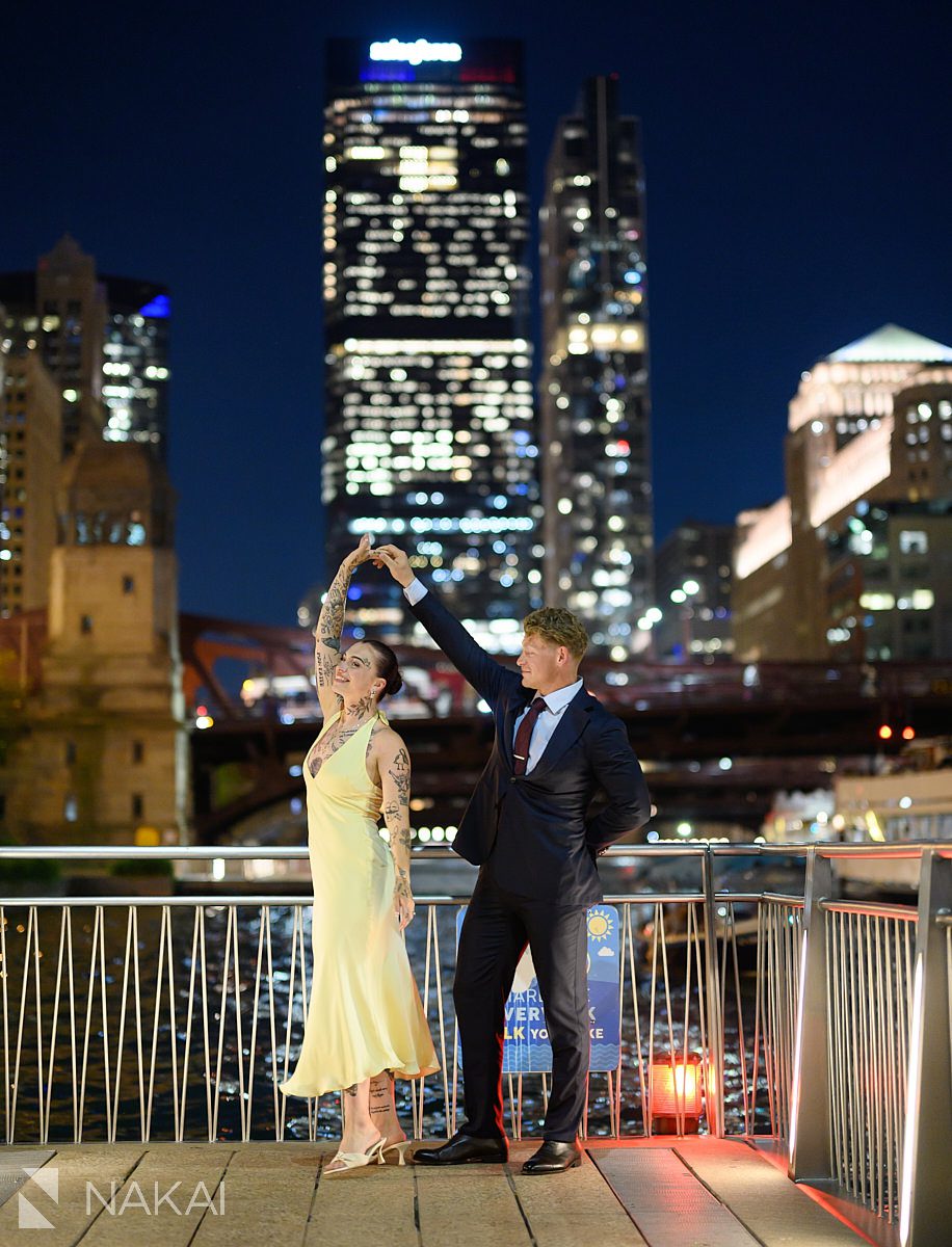 dancing twirl romantic chicago evening riverwalk engagement photo