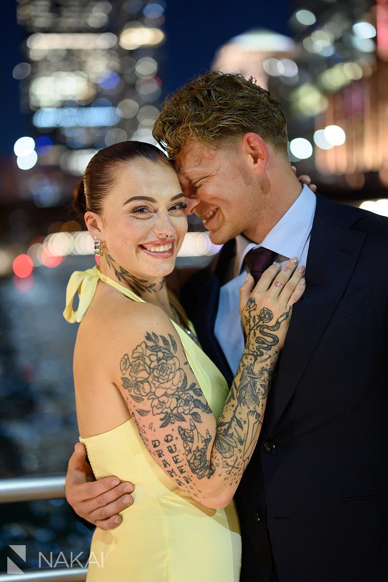 close up smiles romantic chicago night time riverwalk engagement