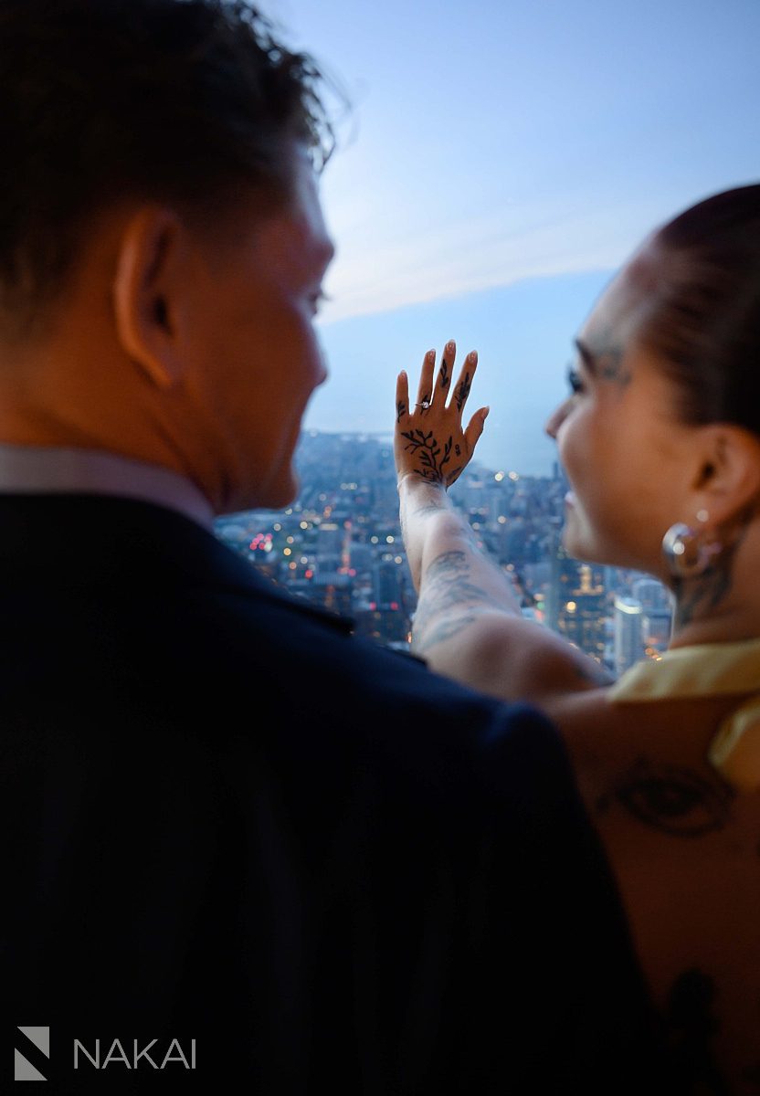 looking at ring on hand at skydeck willis tower proposal 