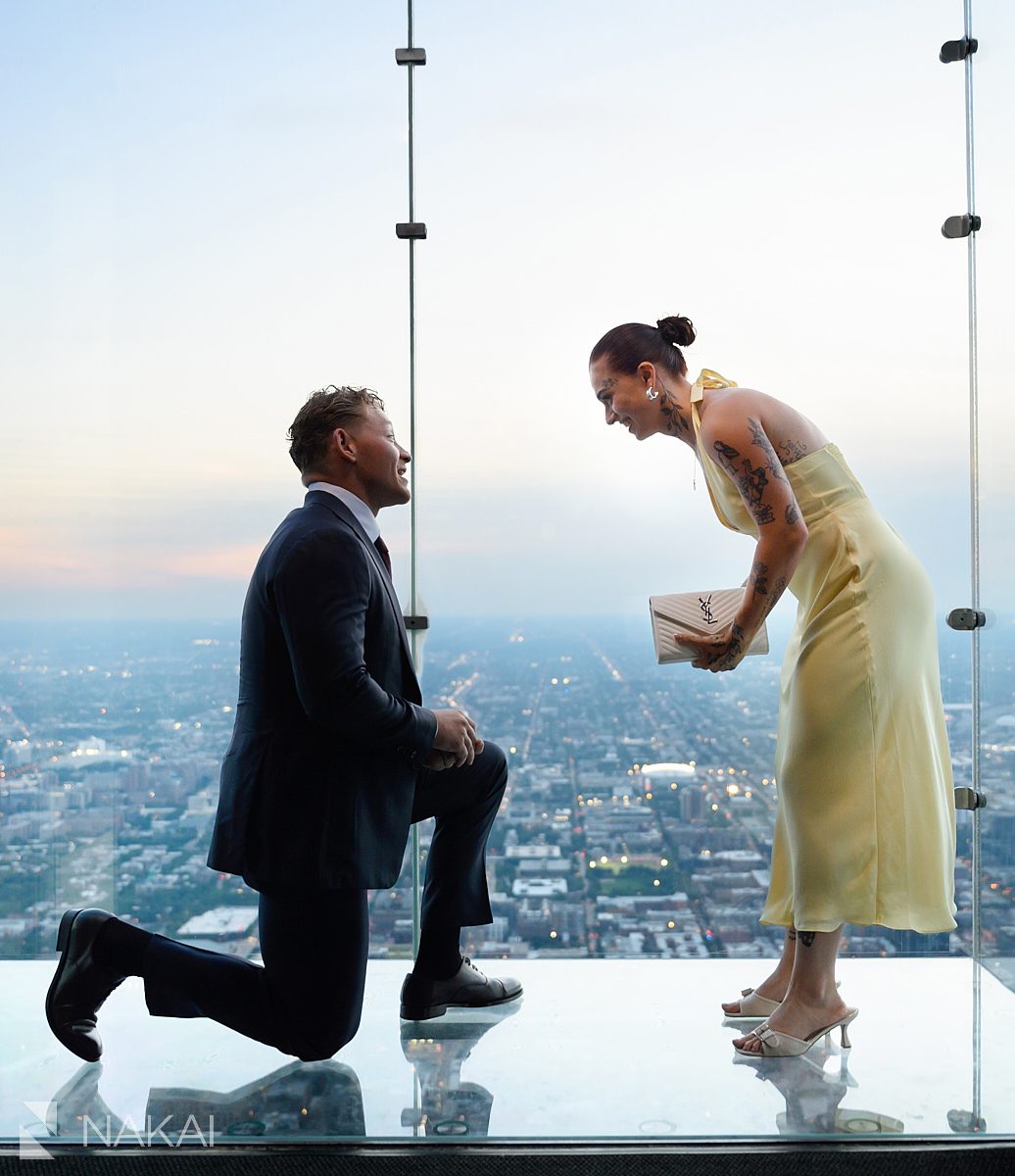 kneeling at chicago skydeck proposal she's in disbelief