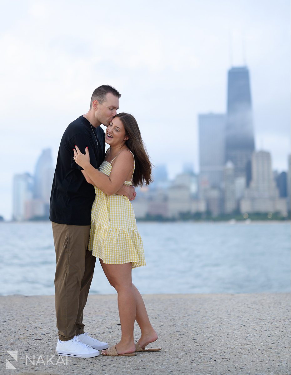 kiss on cheek during chicago lakefront engagement at North Ave beach