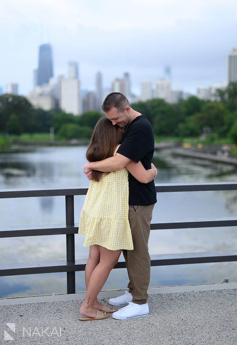 hugging on bridge over south pond during engagement session