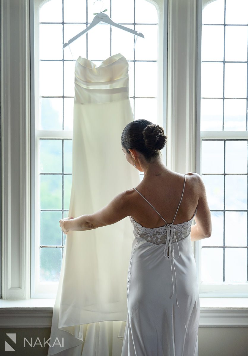 bride prep university club chicago wedding photo looking at dress
