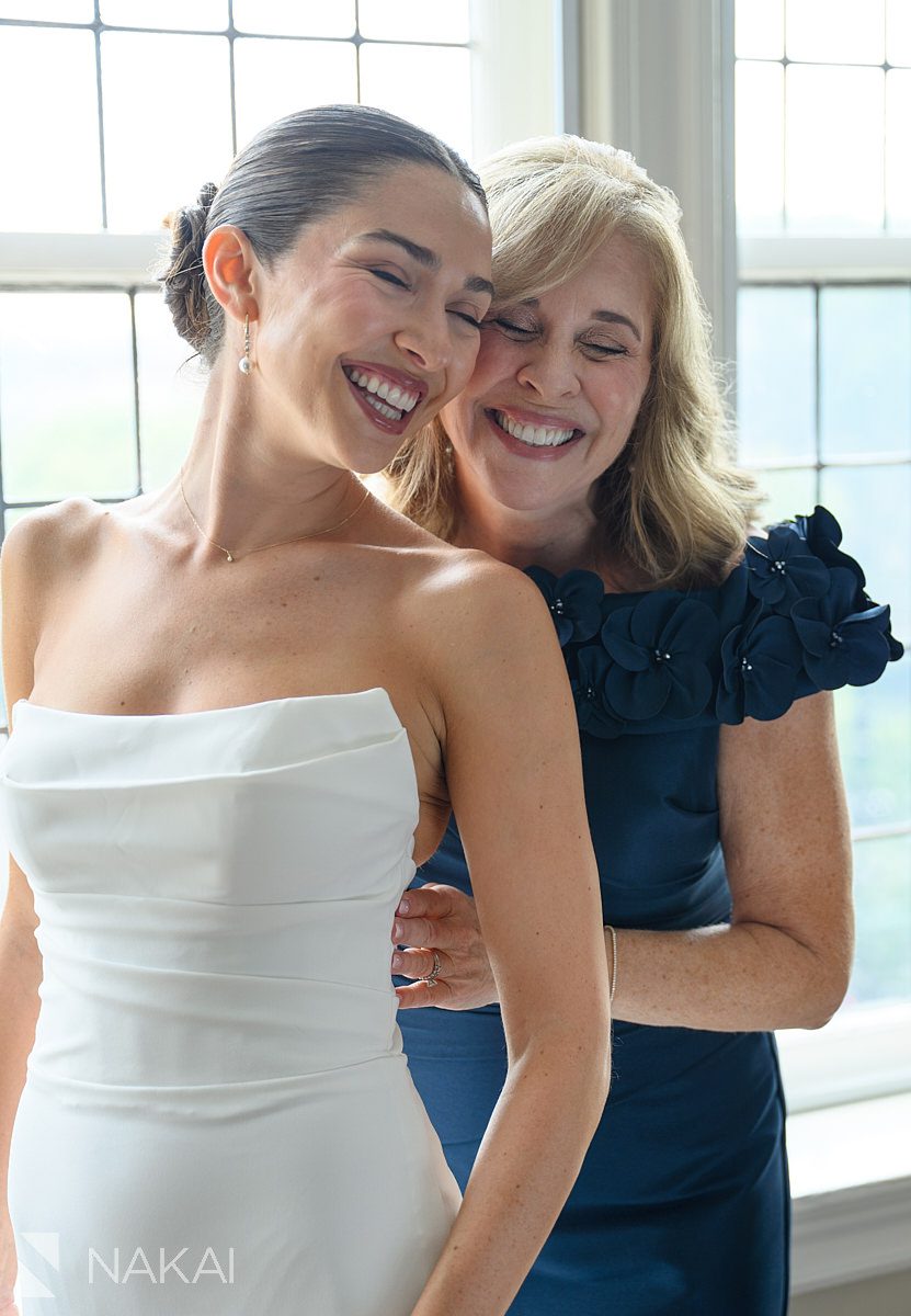 mom putting on dress university club chicago wedding photo