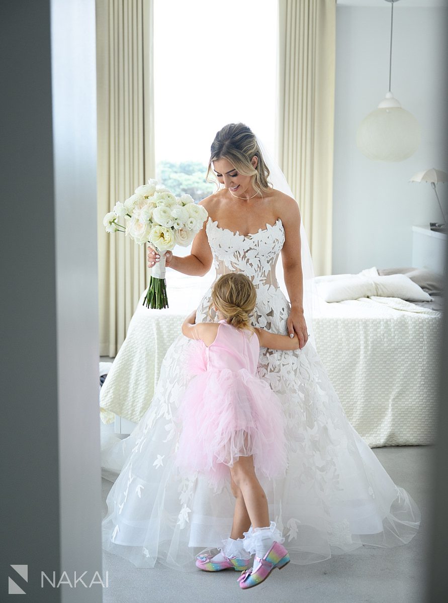 flower girl hugging bride for bridesmaids reveal