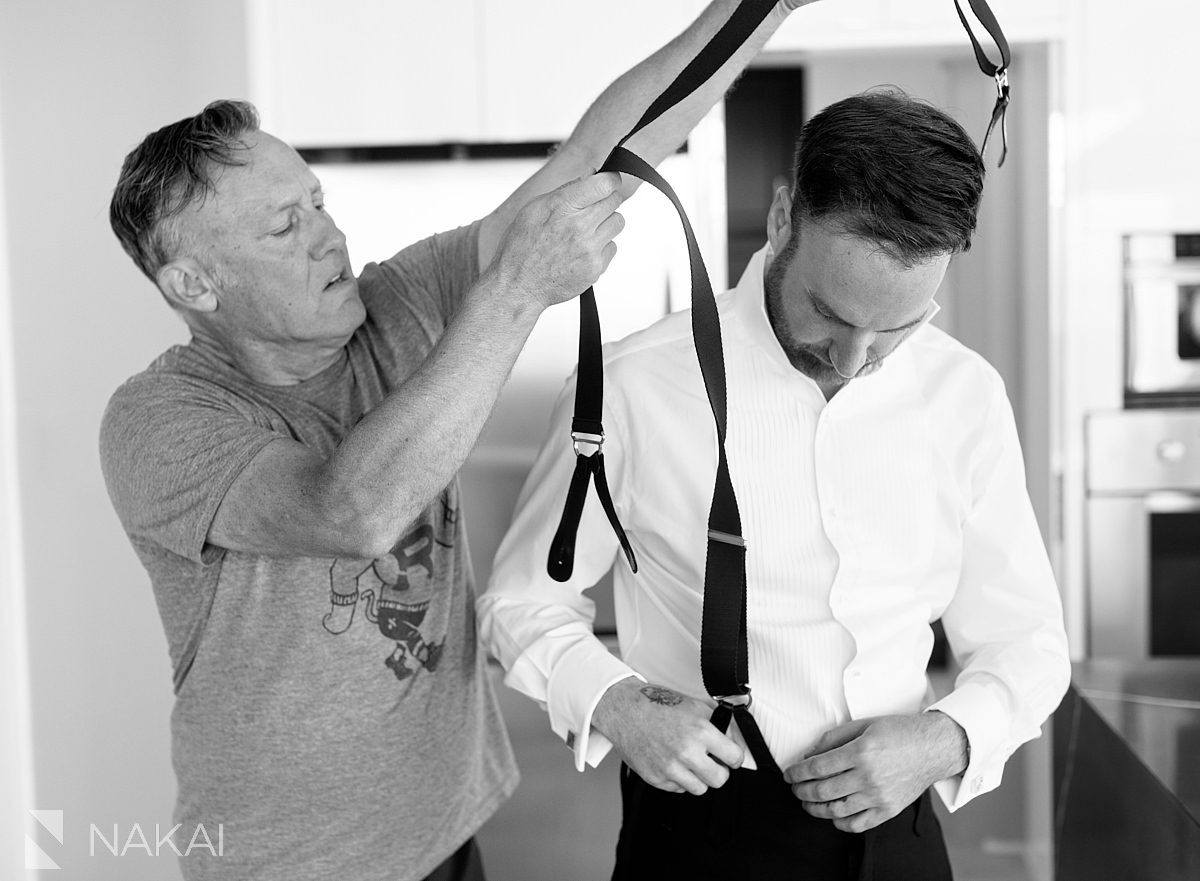 groom getting ready with father