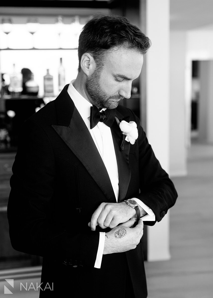 groom getting ready putting on cufflinks