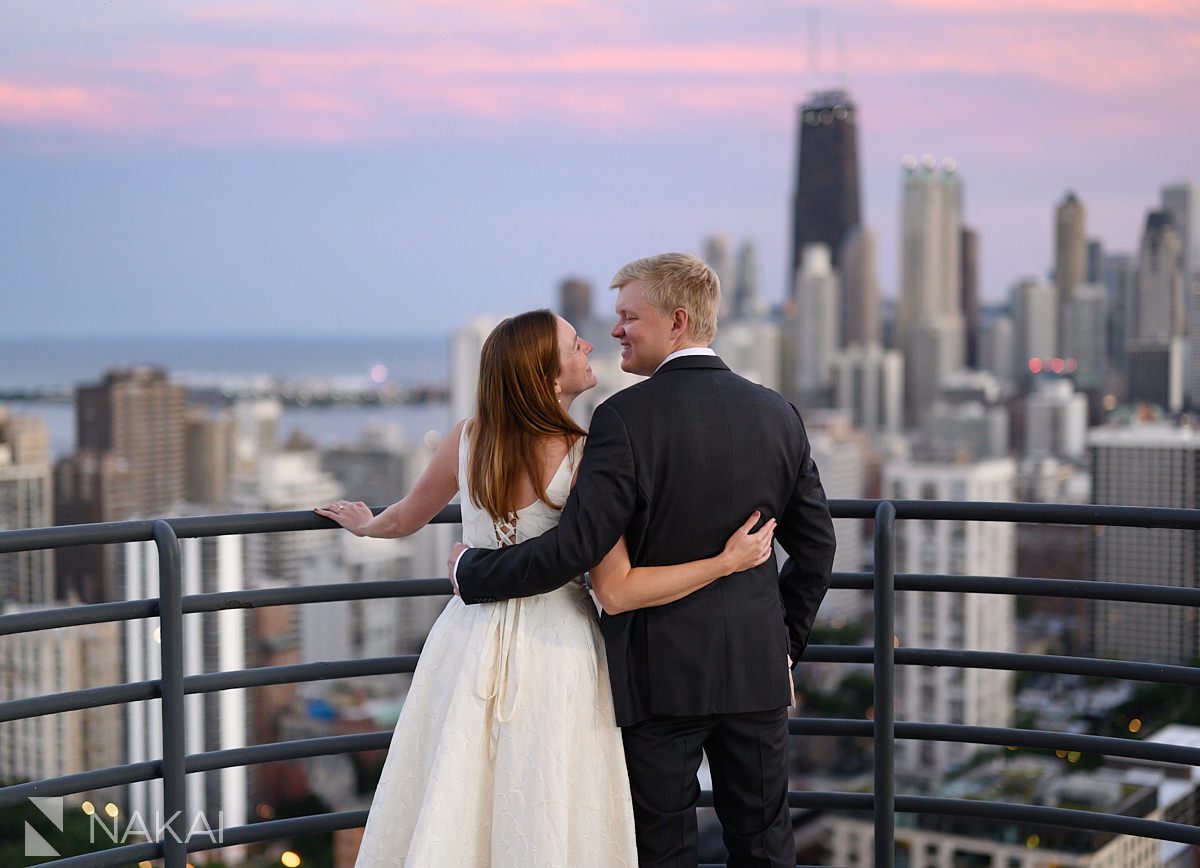 chicago rooftop engagement photos with skyline, couple looking at each other at sunset