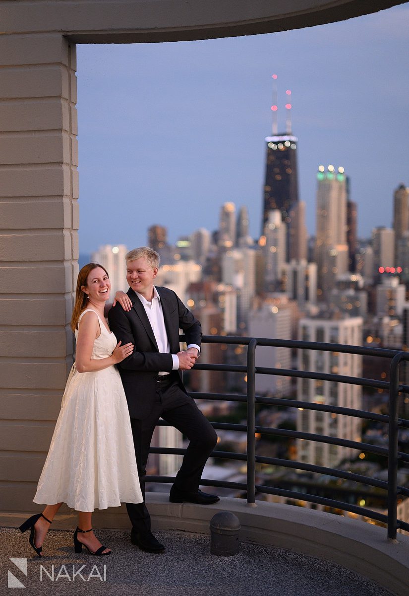 chicago rooftop engagement photos couple together looking at skyline
