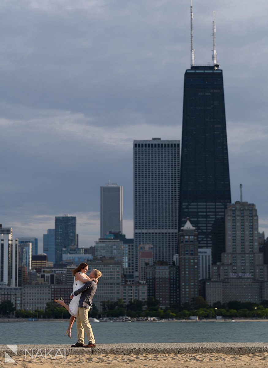north avenue pier engagement photos skyline in background, couple hugging