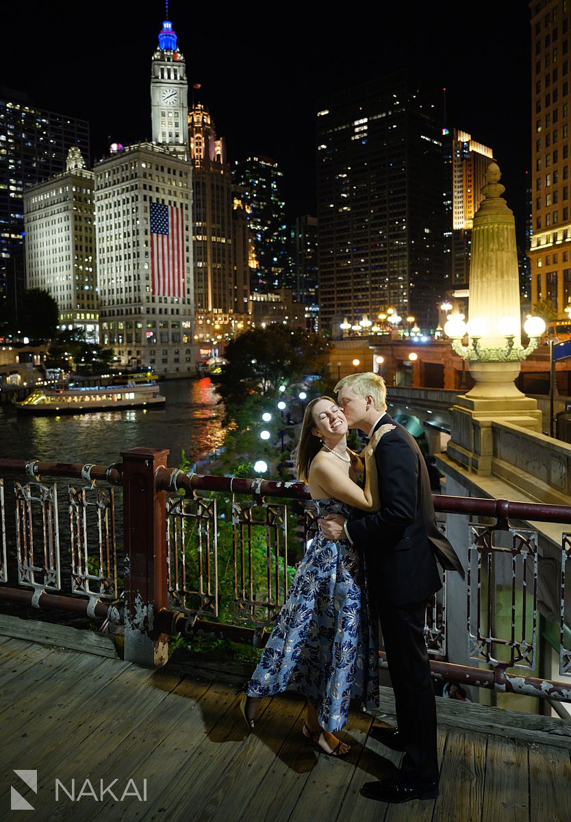 chicago night riverwalk engagement photos couple kissing on bridge