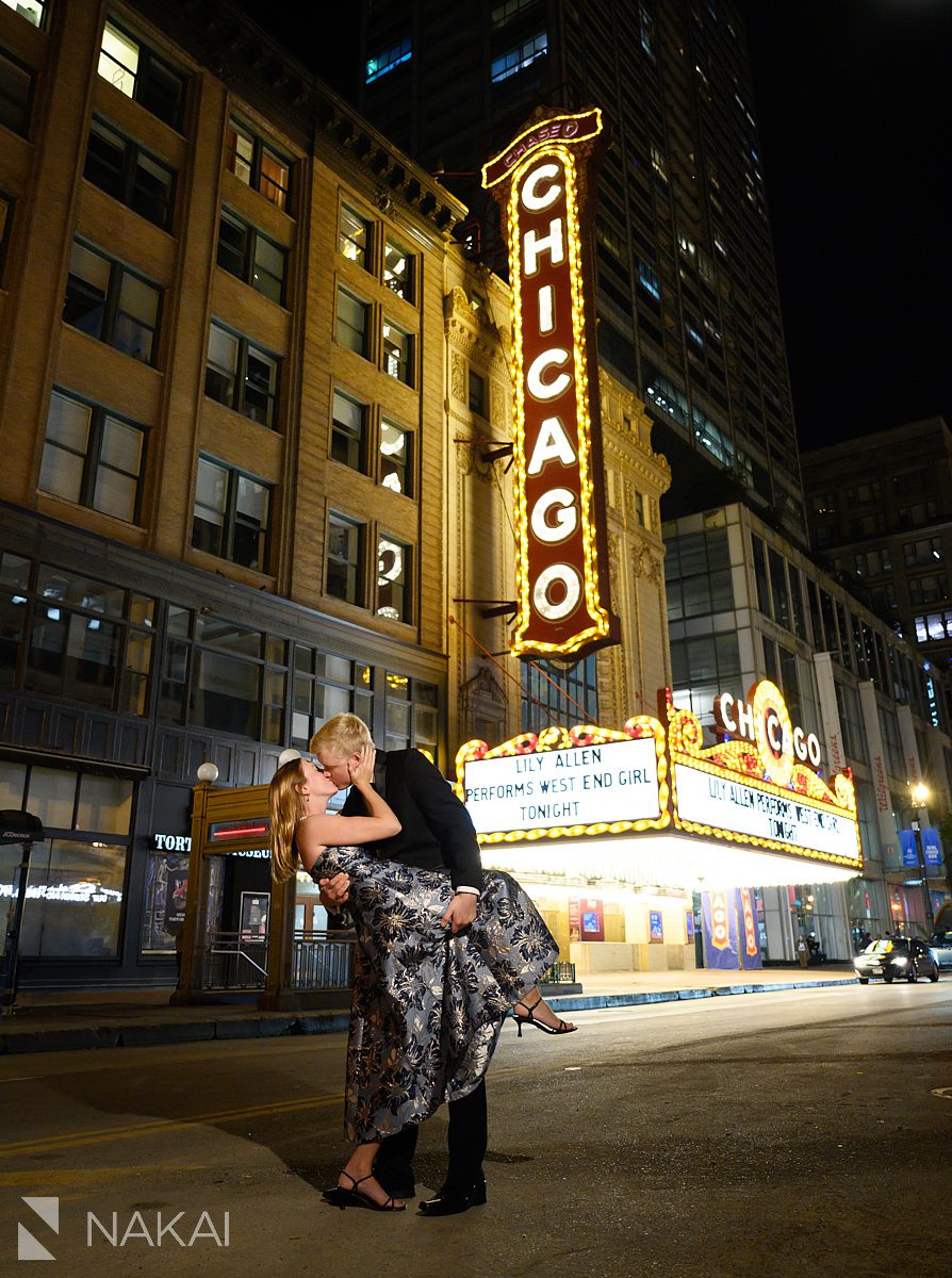 chicago theatre sign engagement photos at night couple dip and kiss
