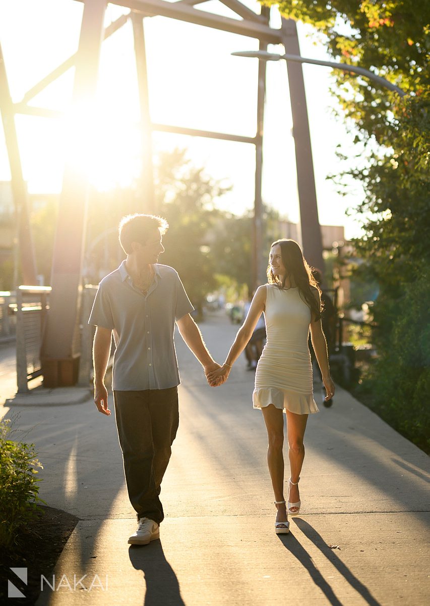 606 Bloomingdale Trail engagement photos couple walking on bridge holding hands