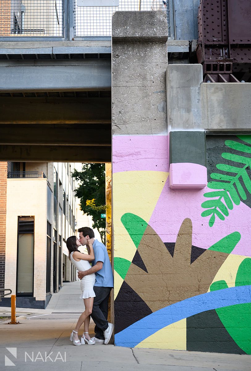 Chicago 606 engagement photos couple kissing next to urban art