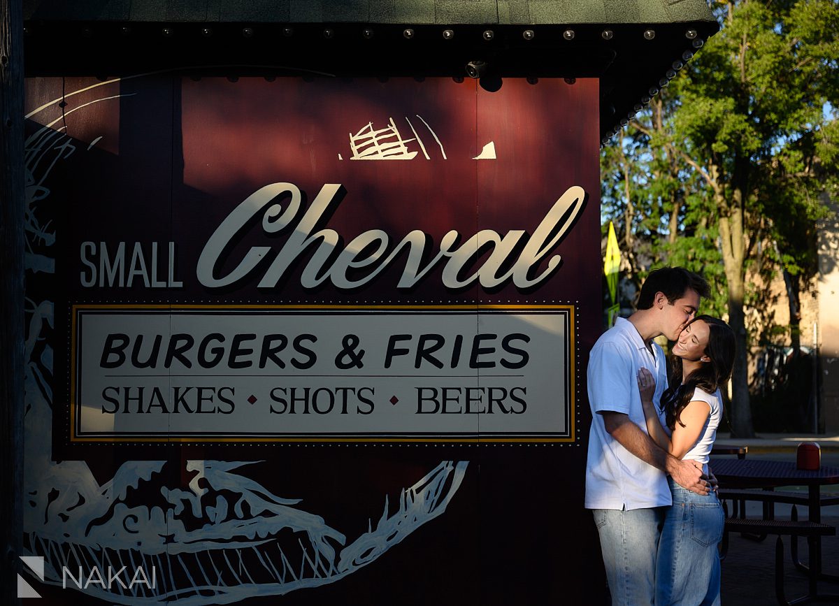 chicago small cheval engagement photos couple laughing next to restaurant