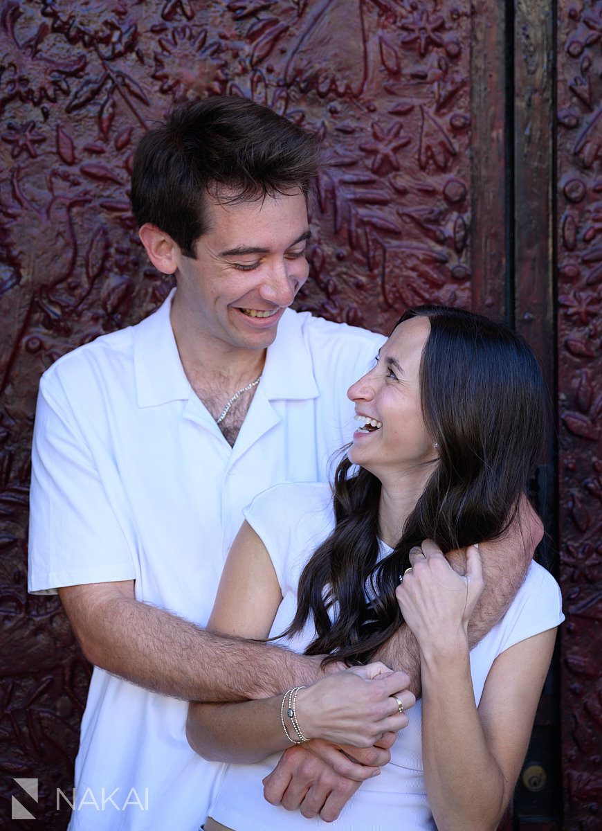 chicago neighborhood engagement photos in wicker park, couple laughing holding each other