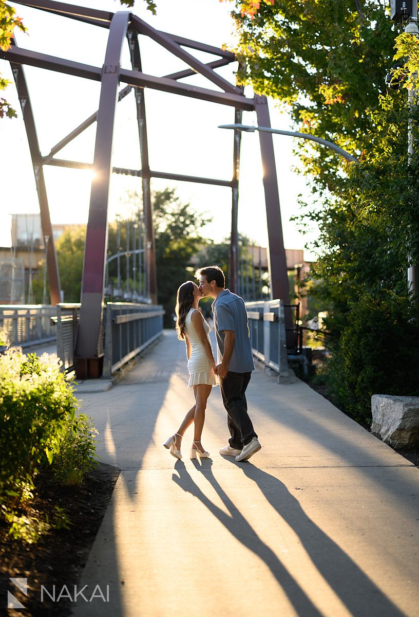 wicker park engagement photos couple kissing by 606 Bloomingdale trail bridge